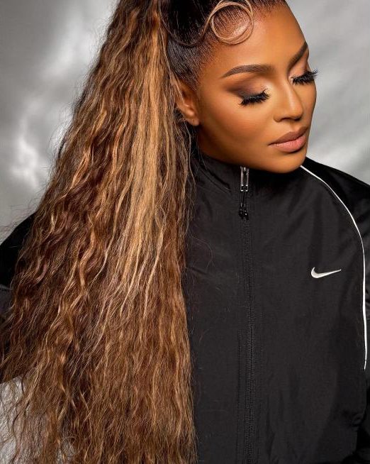 Vietnamese raw hair with highlights styled in a sleek ponytail