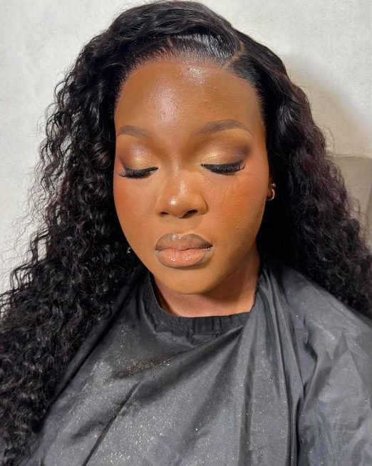 Soft glam makeup with a curly wig